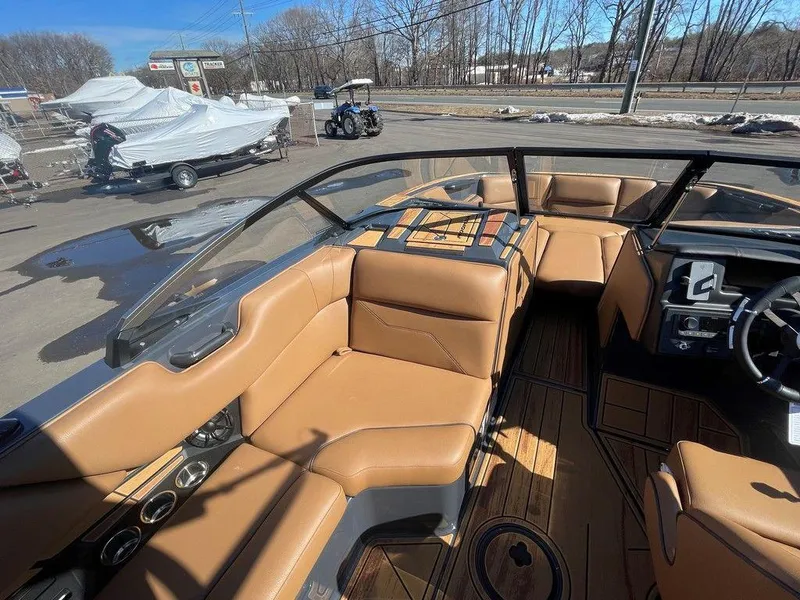 Slide: The Image of 2025 Moomba Max boat interior with tan leather seats and sleek dashboard design. - 31