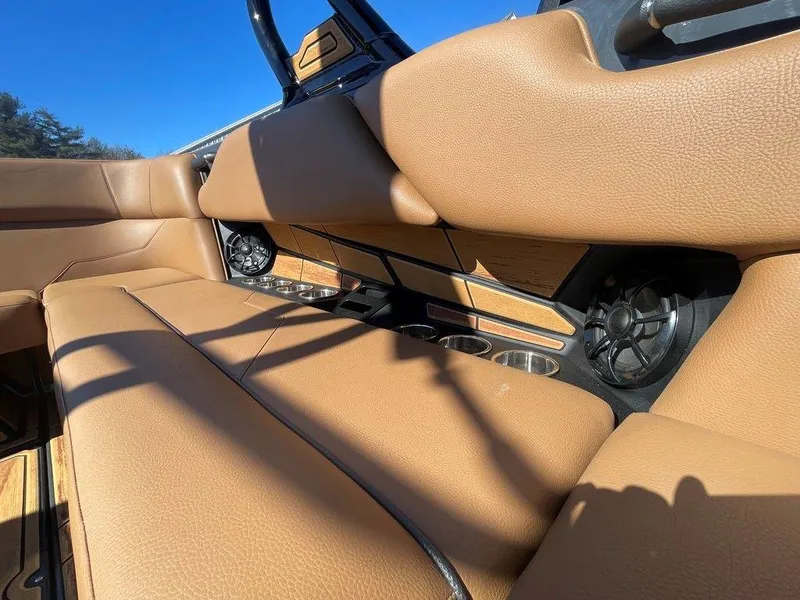 Slide: The Image of 2025 Moomba Max interior with tan leather seats and built-in speakers. - 34