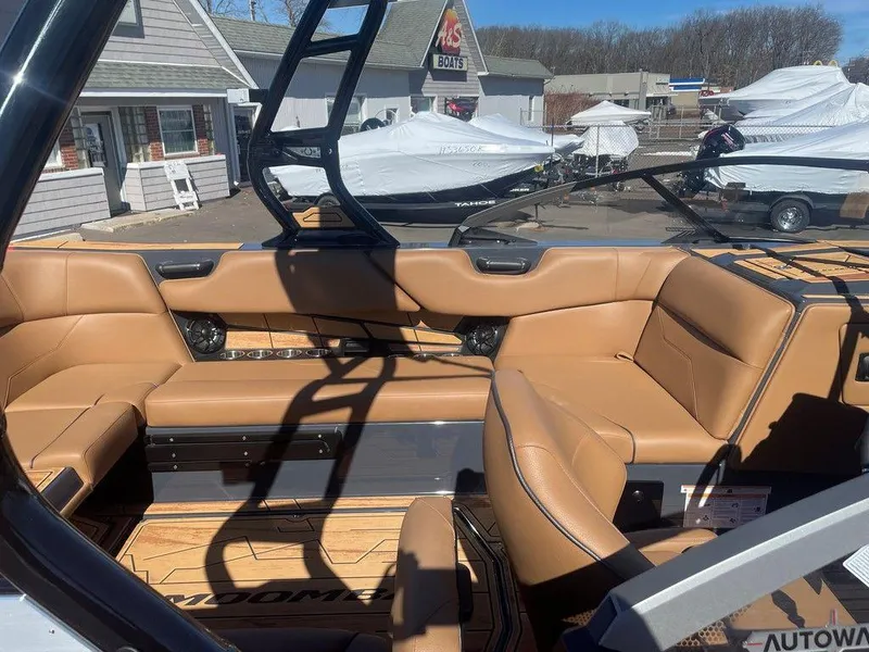 Slide: The Image of 2025 Moomba Max boat interior with tan leather seating and modern design. - 37