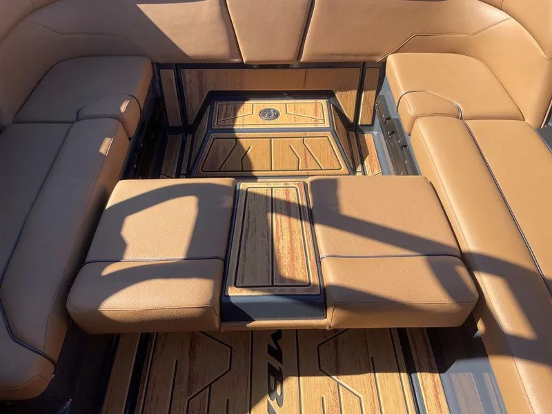 Slide: The Image of 2025 Moomba Max interior with tan seating and wood-style flooring. - 41