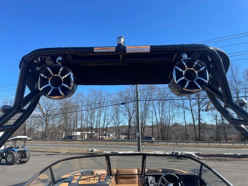 Slide: The Image of 2025 Moomba Max boat with speakers on wakeboard tower, clear blue sky background. - 43