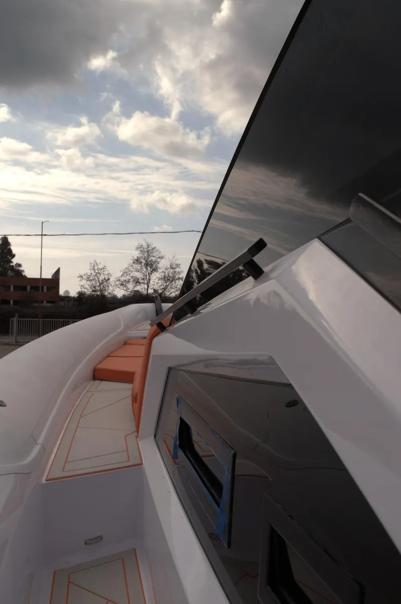 Slide: The Image of Modern DNA 46 yacht exterior, 2025 model, with sleek design and cloudy sky backdrop. - 11