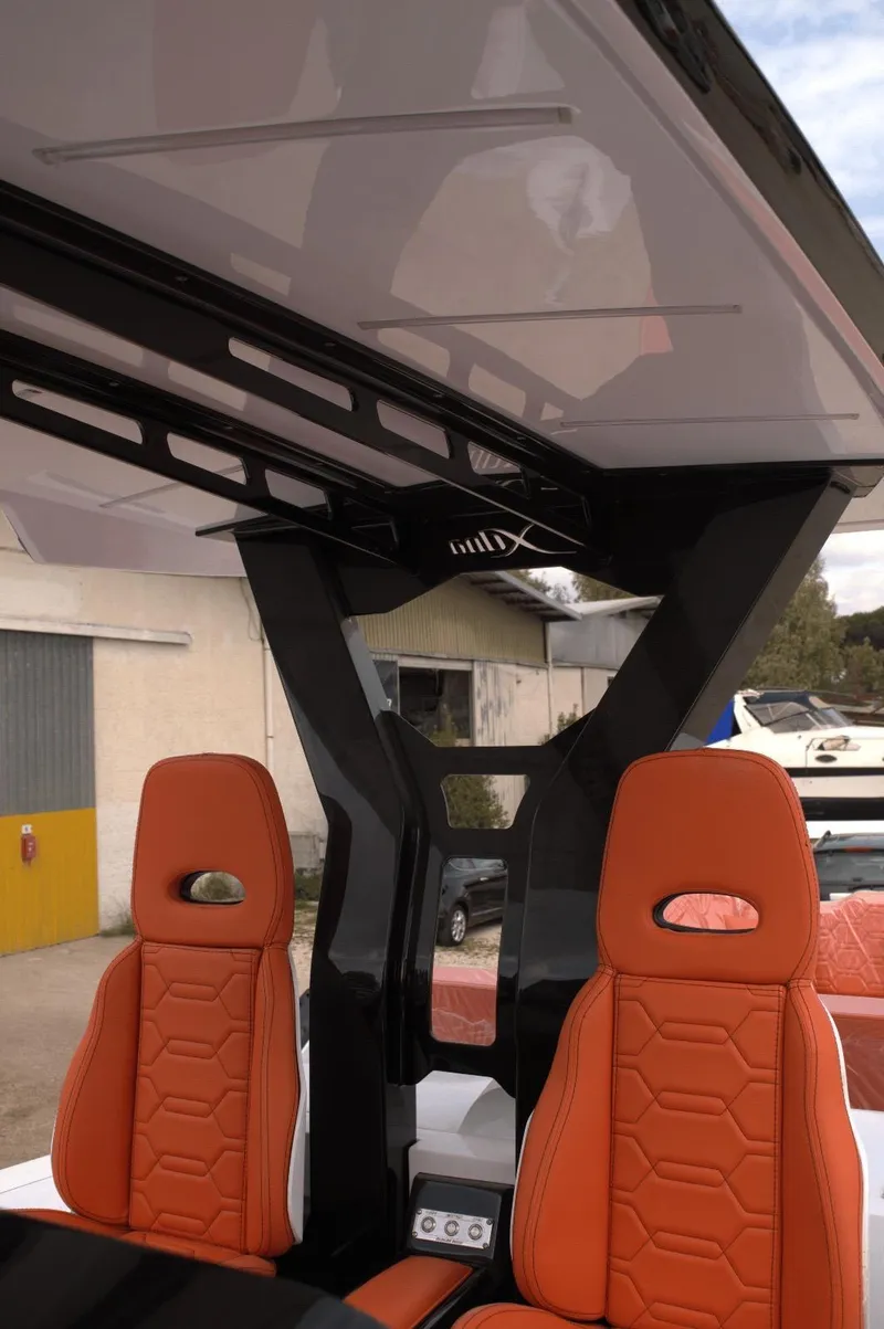 Slide: The Image of 2025 DNA 46 boat interior with orange seats and modern design elements. - 12