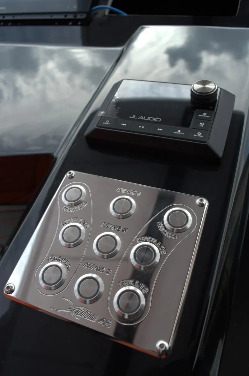 Slide: The Image of Control panel and audio system on DNA 46, 2025 model, featuring sleek metallic buttons. - 14