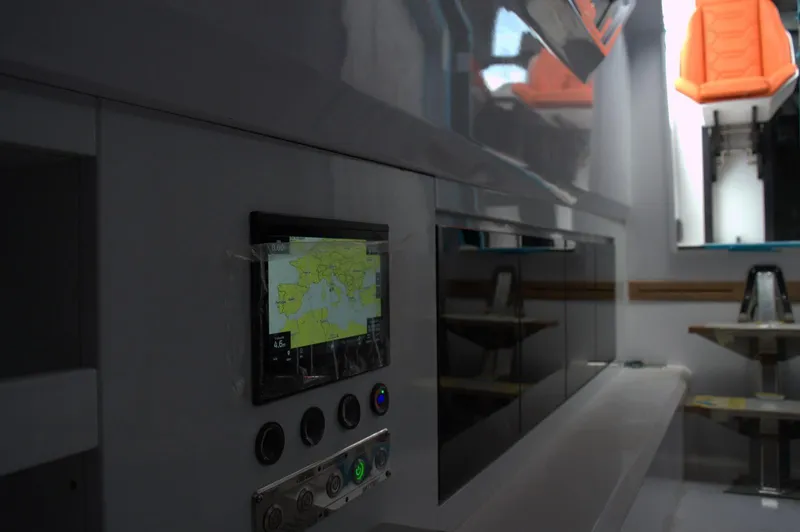 Slide: The Image of Modern interior of DNA 46 yacht, featuring navigation controls and sleek design, 2025 model. - 23