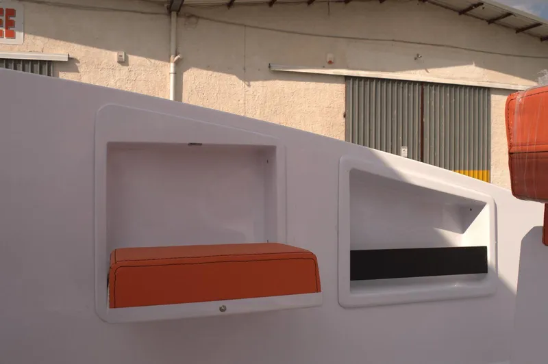 Slide: The Image of Storage compartments on a 2025 DNA 46 boat, featuring orange accents and modern design. - 6