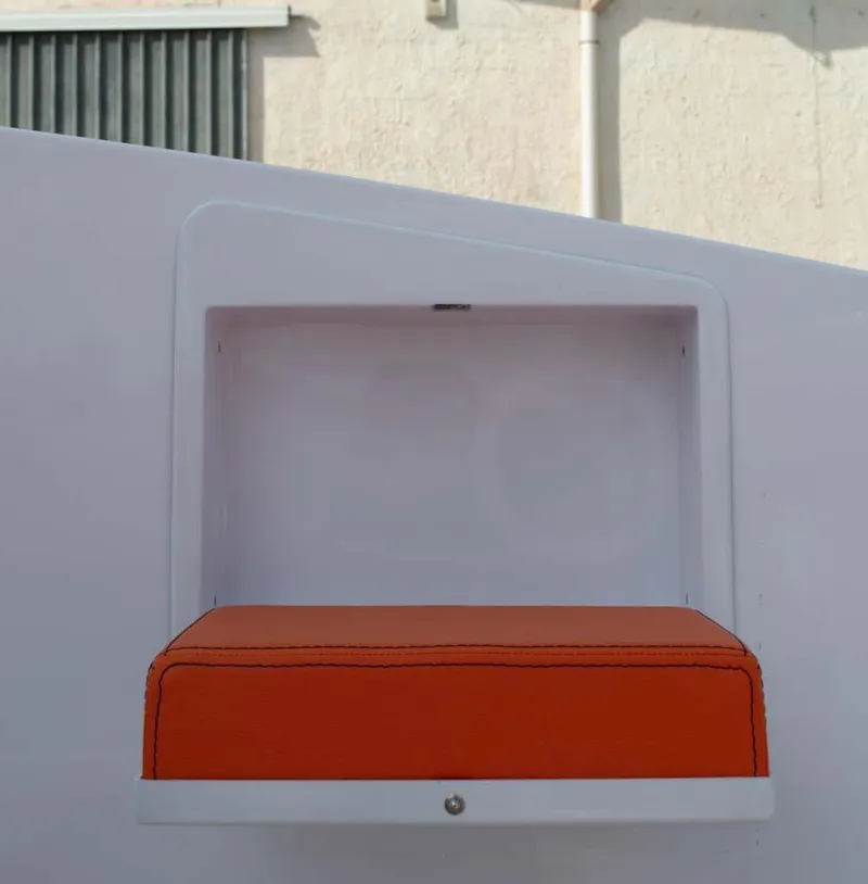 Slide: The Image of Orange cushioned seat in a modern, minimalist design, DNA 46 model, 2025. - 7