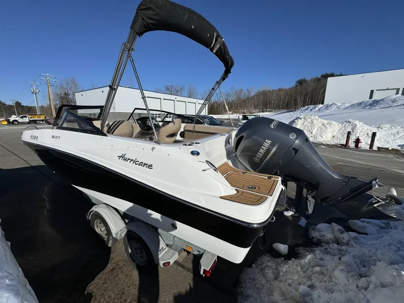 Slide: The Image of 2018 Hurricane SunDeck 217 OB boat with Yamaha outboard motor, parked on snowy pavement. - 3