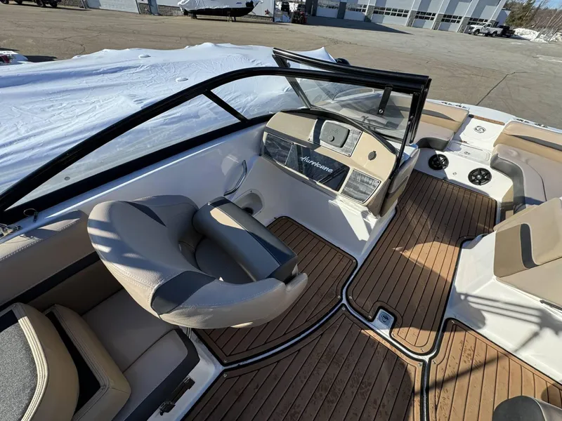 Slide: The Image of 2018 Hurricane SunDeck 217 OB interior with tan seating and wood-style flooring. - 7