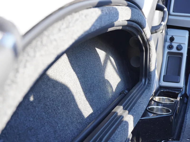 Slide: The Image of Interior view of 2025 Ranger 1880MS boat, featuring storage compartment and cup holders. - 10