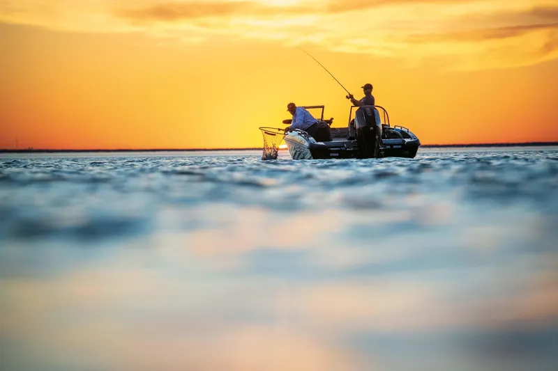 Slide: The Image of Two people fishing on a Ranger 1880MS boat at sunset, 2025 model. - 14