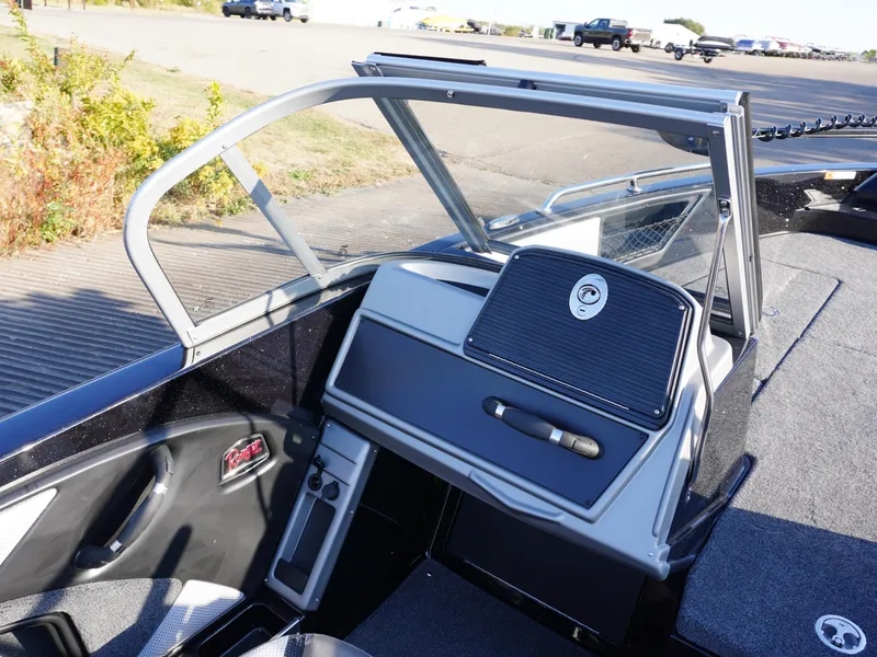 Slide: The Image of 2025 Ranger 1880MS boat interior with windshield and dashboard, parked outdoors. - 7