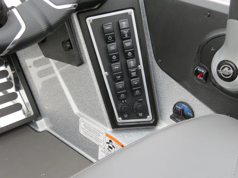 Slide: The Image of Control panel of 2025 Ranger Z519R Cup-Equipped boat with multiple switches and steering wheel. - 7
