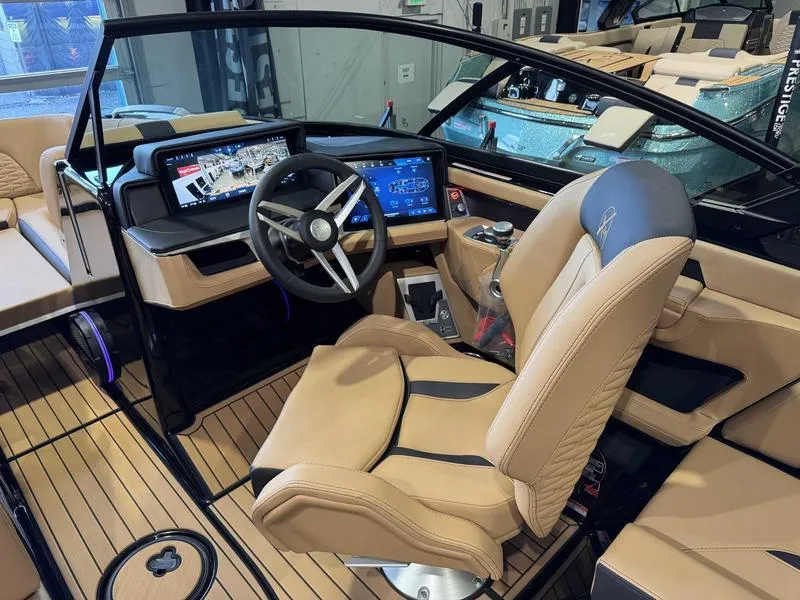 Slide: The Image of 2025 MasterCraft X24 boat interior with modern dashboard and luxurious seating. - 11