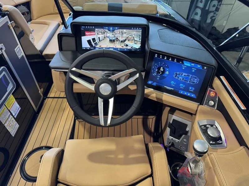 Slide: The Image of 2025 MasterCraft X24 boat dashboard with advanced digital displays and modern steering wheel. - 12