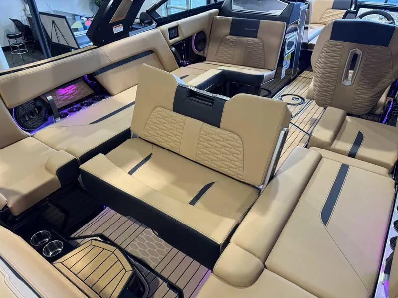 Slide: The Image of 2025 MasterCraft X24 boat interior with luxurious beige seating and modern design. - 15