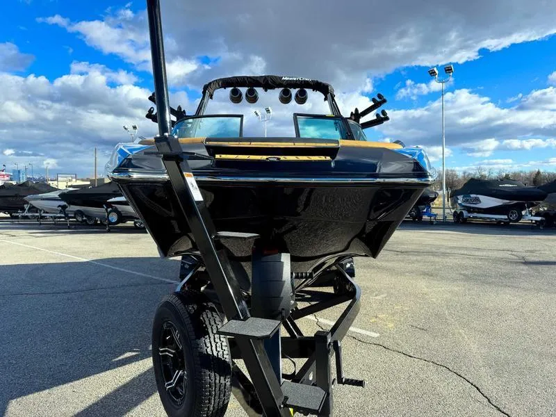 Slide: The Image of 2025 MasterCraft X24 boat on trailer under blue sky. - 4