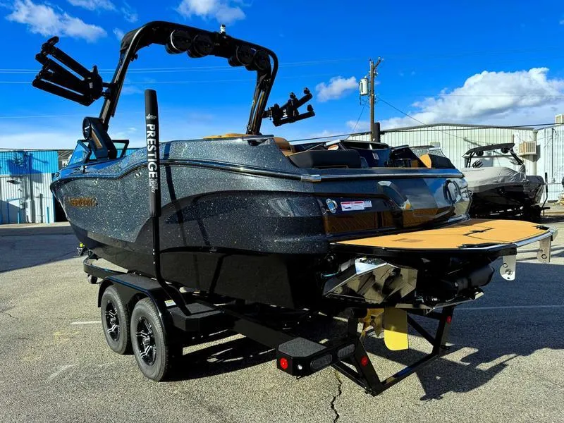 Slide: The Image of 2025 MasterCraft X24 boat on trailer, sleek design, sunny day, industrial background. - 6