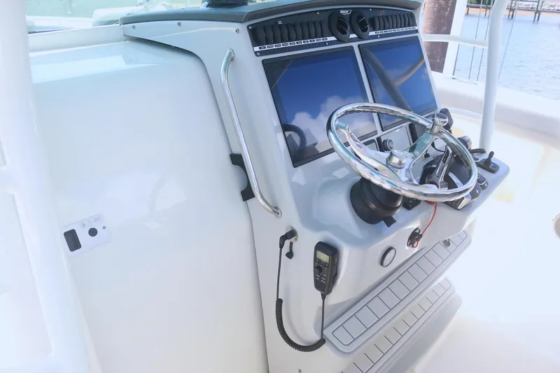 Slide: The Image of 2022 Boston Whaler 380 Outrage helm with dual screens and steering wheel. - 14