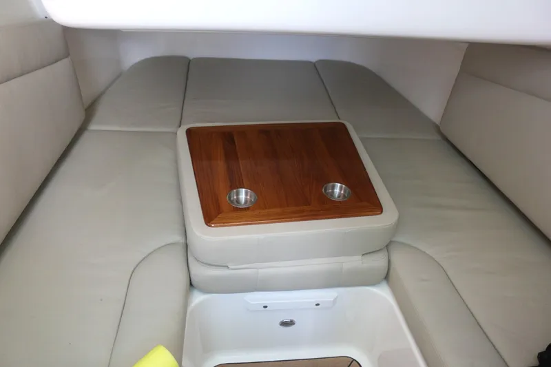Slide: The Image of Interior cabin of 2022 Boston Whaler 380 Outrage with cushioned seating and wooden table. - 15
