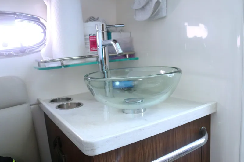 Slide: The Image of 2022 Boston Whaler 380 Outrage bathroom with glass sink and modern faucet. - 17
