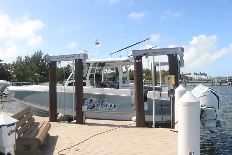 Slide: The Image of Boston Whaler 380 Outrage 2022 docked at a sunny marina. - 5
