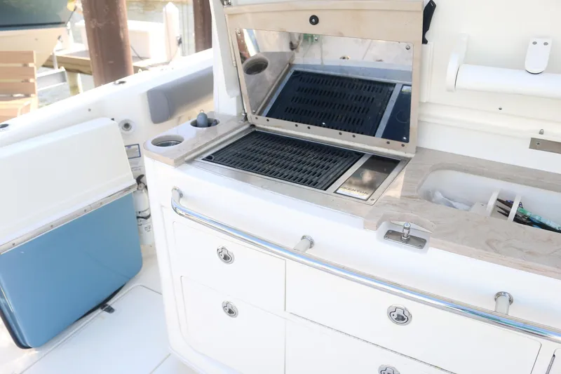 Slide: The Image of Boston Whaler 380 Outrage 2022 boat kitchen with grill and storage drawers. - 8