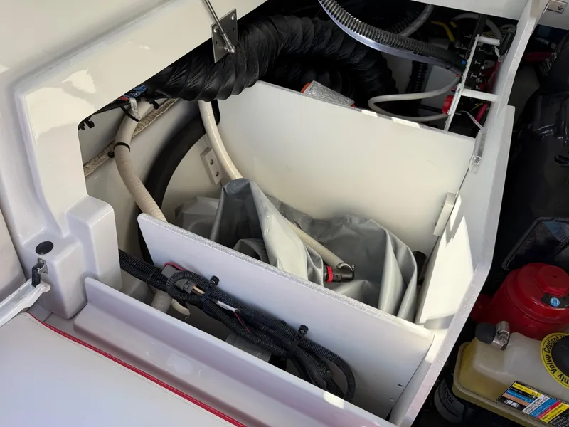 Slide: The Image of 2024 Crownline 220 SS SURF boat interior showing storage compartment and equipment. - 13