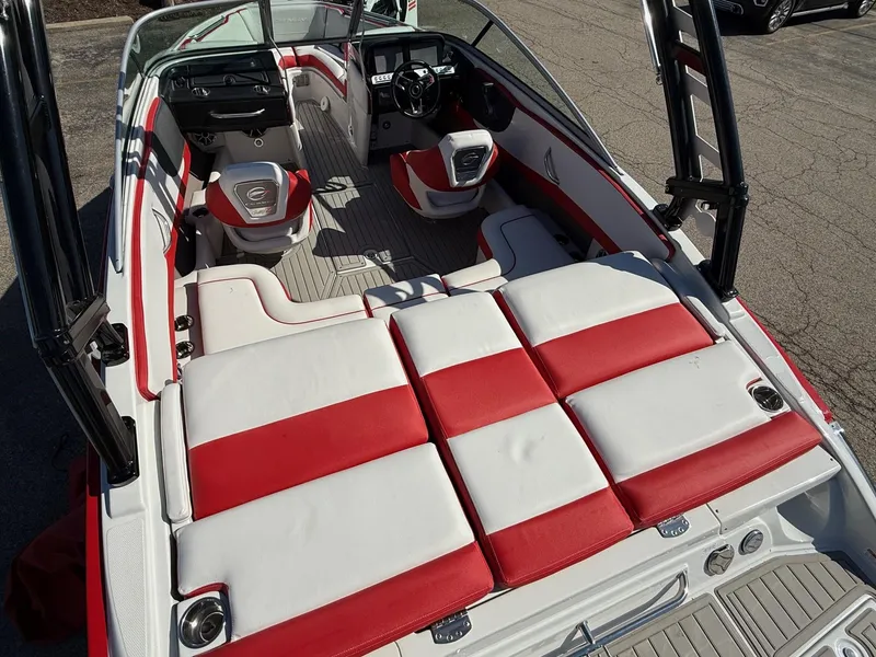 Slide: The Image of 2024 Crownline 220 SS SURF boat interior with red and white seating, sleek design. - 2