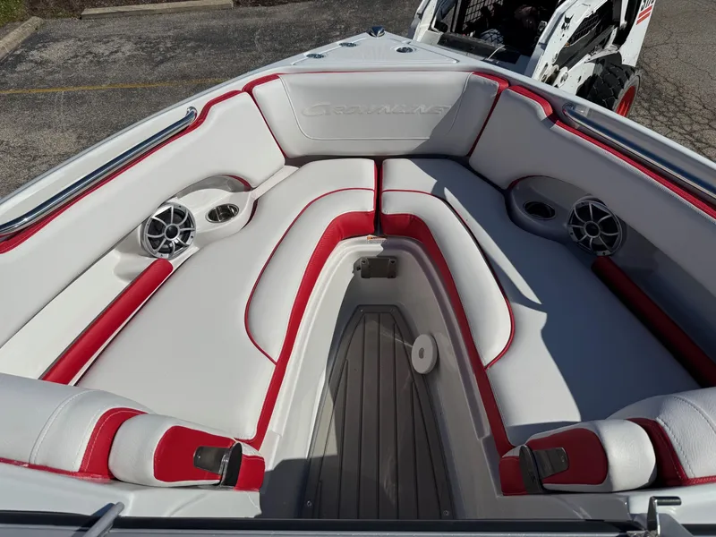 Slide: The Image of 2024 Crownline 220 SS SURF boat interior with red and white seating and speakers. - 3