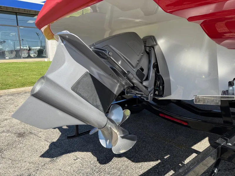 Slide: The Image of 2024 Crownline 220 SS SURF boat propeller and stern detail in a showroom setting. - 8