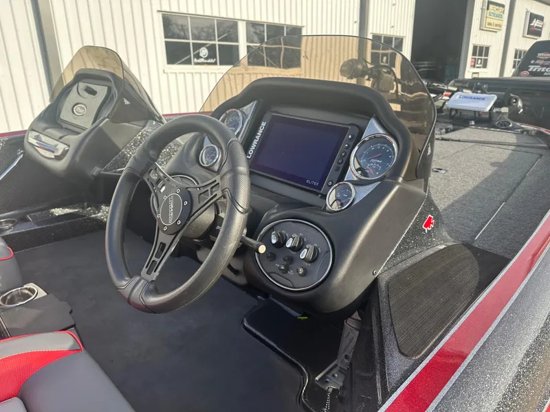 Slide: The Image of 2023 Triton 18 TrX boat dashboard with steering wheel and control panel. - 6