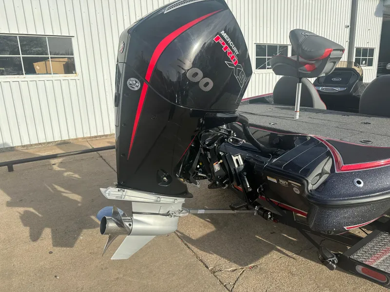 Slide: The Image of 2023 Triton 18 TrX boat with powerful outboard motor, parked outdoors. - 7