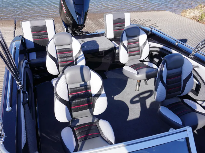Slide: The Image of 2025 Ranger 2080MS boat interior with six seats, black and white design, near water. - 11