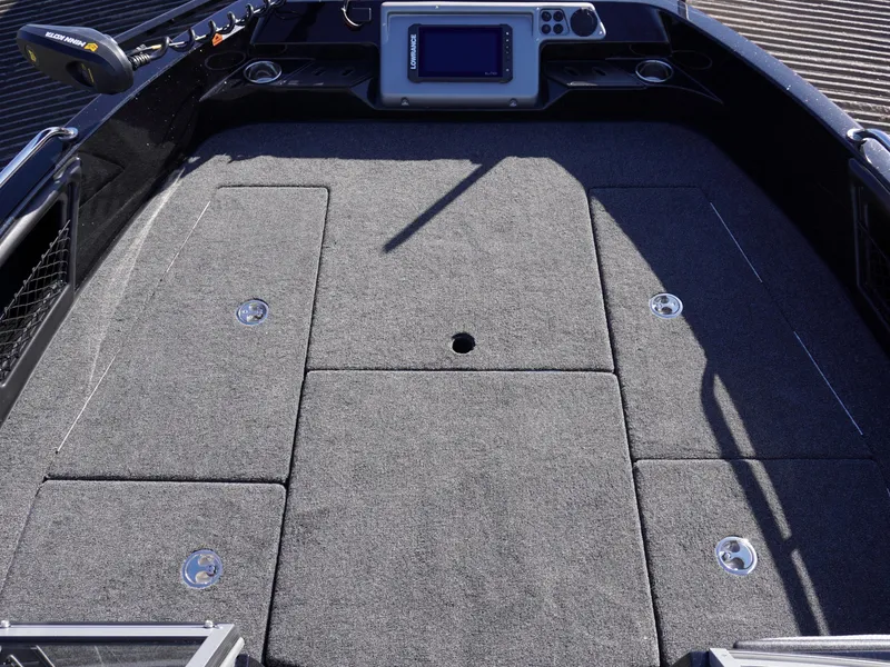 Slide: The Image of 2025 Ranger 2080MS boat deck with carpeted surface and control panel. - 13