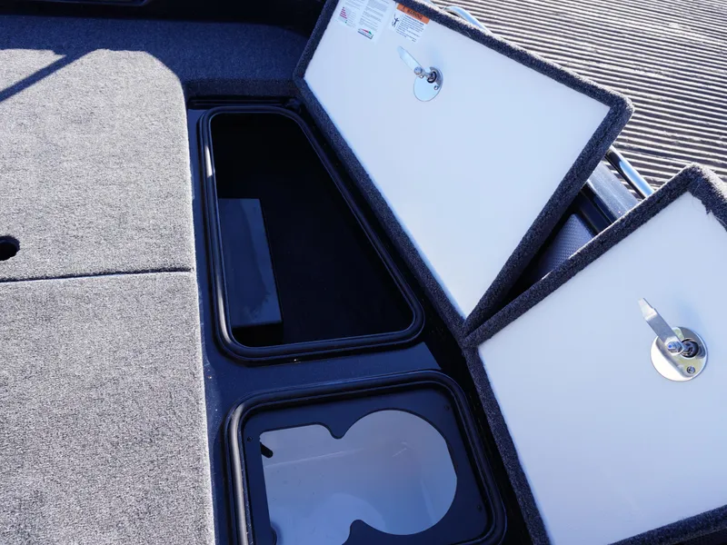 Slide: The Image of Ranger 2080MS 2025 boat storage compartments with open lids, showcasing interior space. - 14