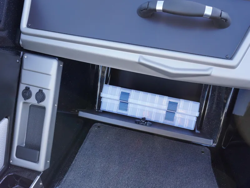 Slide: The Image of Interior storage compartment of 2025 Ranger 2080MS with organized tackle box. - 18