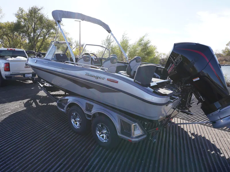 Slide: The Image of 2025 Ranger 2080MS boat on trailer, parked outdoors, with outboard motor. - 5