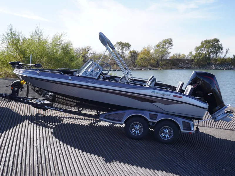 Slide: The Image of 2025 Ranger 2080MS boat on trailer by a lakeside ramp. - 6