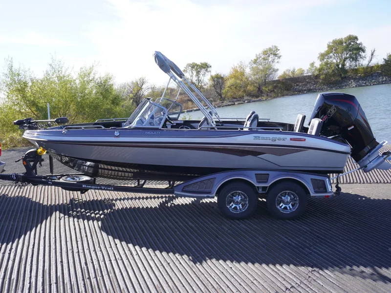 Slide: The Image of 2025 Ranger 2080MS boat on trailer by a river, ready for launch. - 7