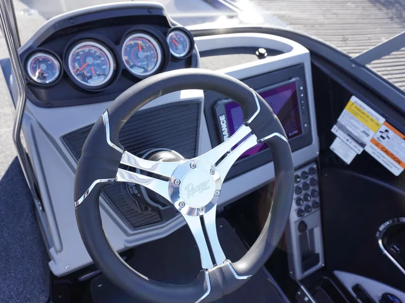 Slide: The Image of Steering wheel and dashboard of 2025 Ranger 2080MS boat with gauges and controls. - 8