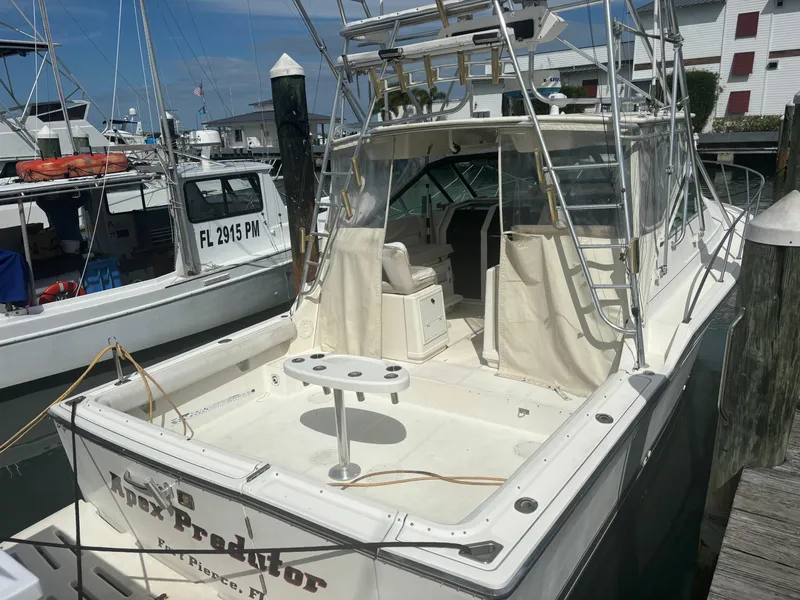 Slide: The Image of 1995 Tiara Yachts 3600 Open docked, featuring spacious deck and fishing equipment. - 10