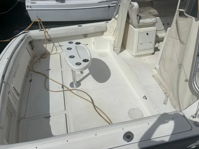 Slide: The Image of 1995 Tiara Yachts 3600 Open deck with seating and fishing rod holders. - 11