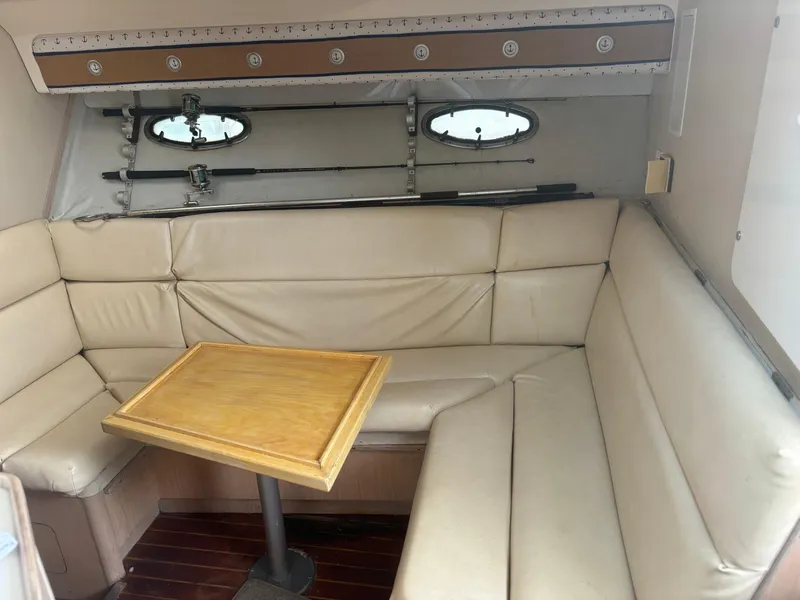 Slide: The Image of 1995 Tiara Yachts 3600 Open interior with beige seating and wooden table. - 14