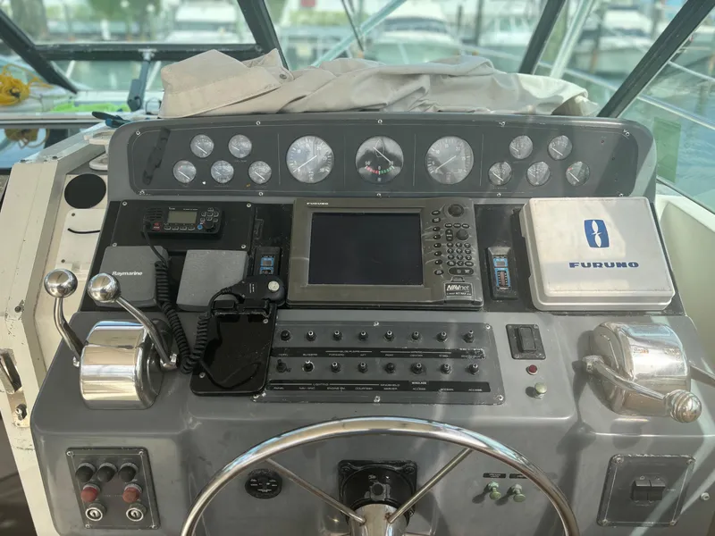 Slide: The Image of 1995 Tiara Yachts 3600 Open helm with navigation equipment and controls. - 2