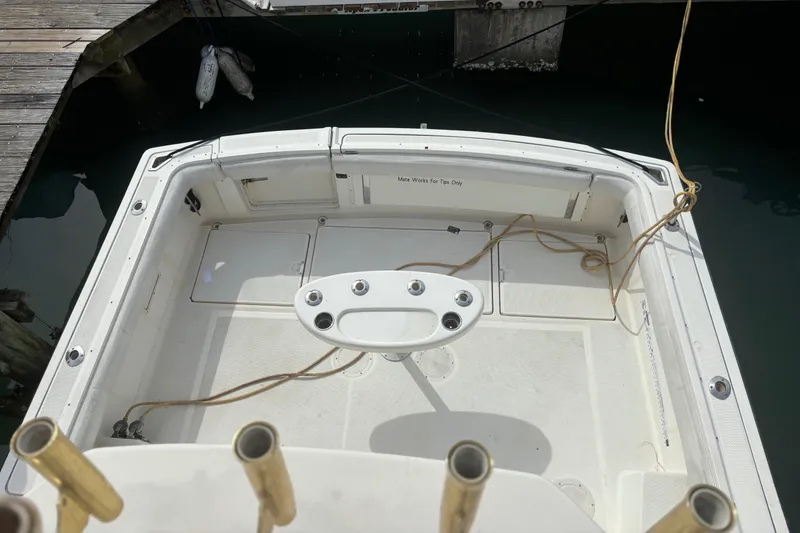 Slide: The Image of 1995 Tiara Yachts 3600 Open boat deck with fishing rod holders and storage compartments. - 7