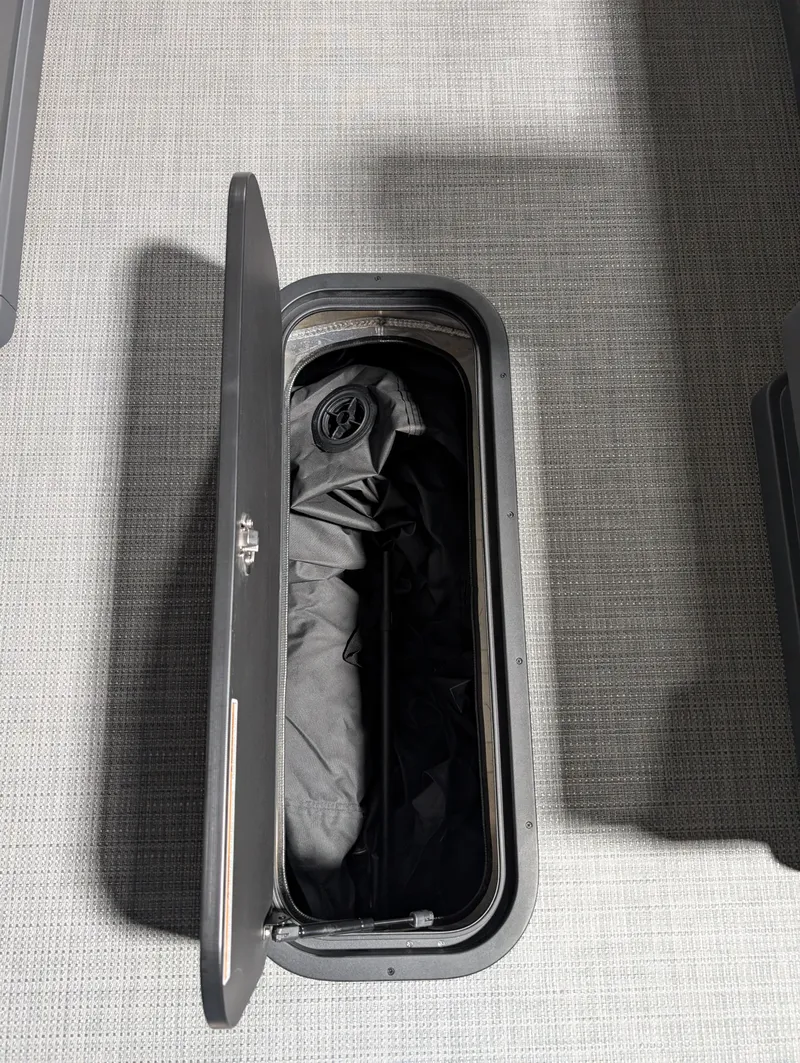 Slide: The Image of Open storage compartment in 2025 Manitou 22 CRUISE boat, featuring sleek design and ample space. - 13