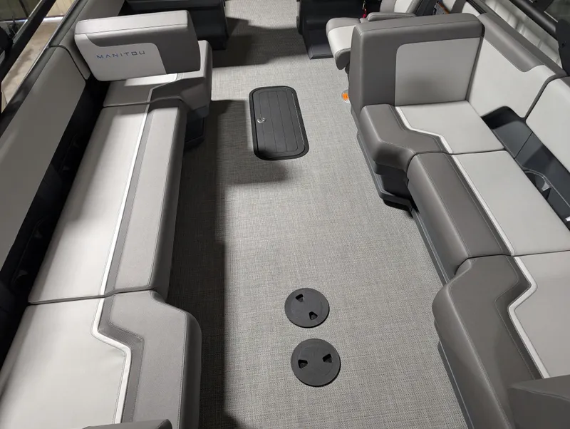 Slide: The Image of 2025 Manitou 22 CRUISE interior with gray seating and carpeted flooring. - 5