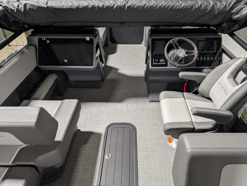 Slide: The Image of 2025 Manitou 22 CRUISE boat interior with modern seating and steering console. - 6