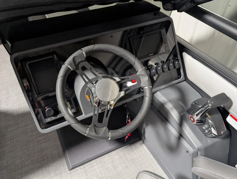 Slide: The Image of 2025 Manitou 22 CRUISE boat dashboard with steering wheel and control panel. - 8